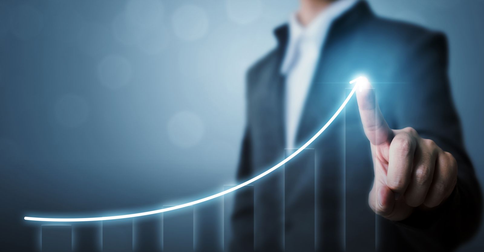 Businessman pointing arrow graph corporate future growth by Marchmeena29 via iStock