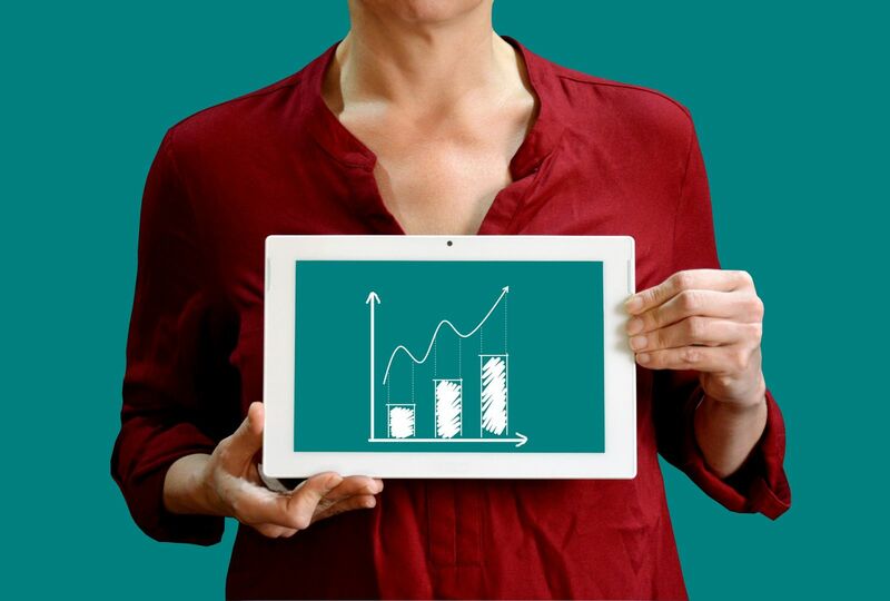 Charts, tickers, traders - Woman Holding Chart of Prices