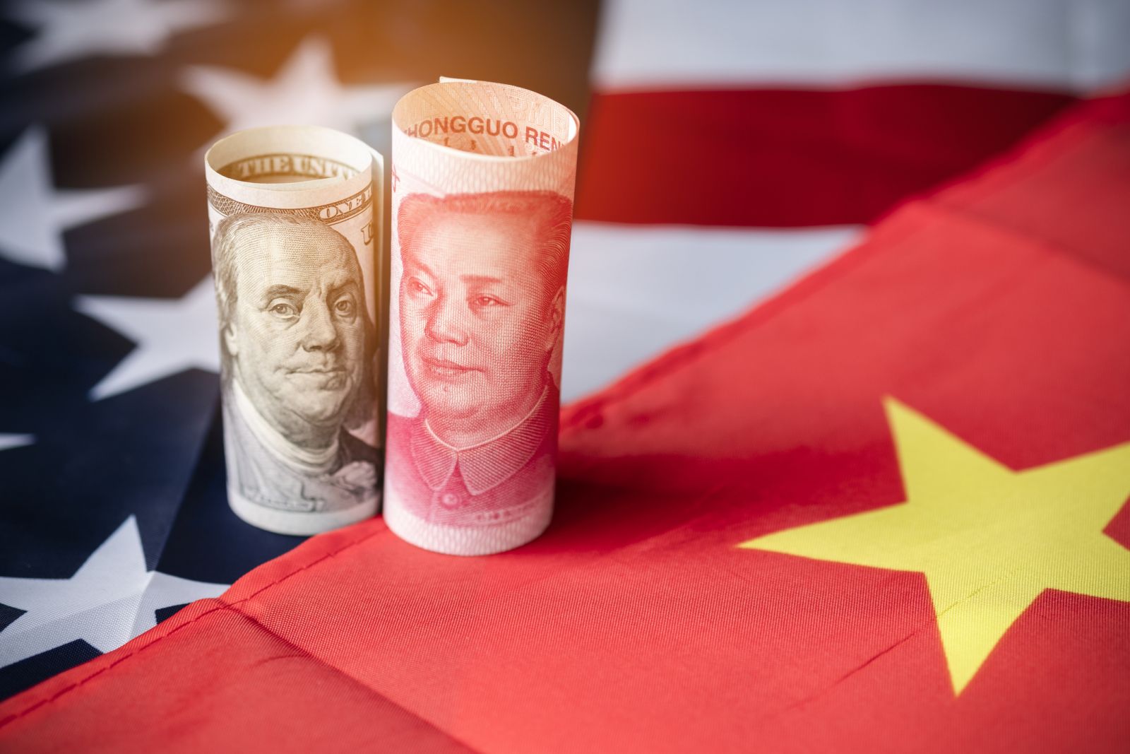 China - US dollar and Yuan banknote on USA and China flags by Dilok Klaisataporn via iStock