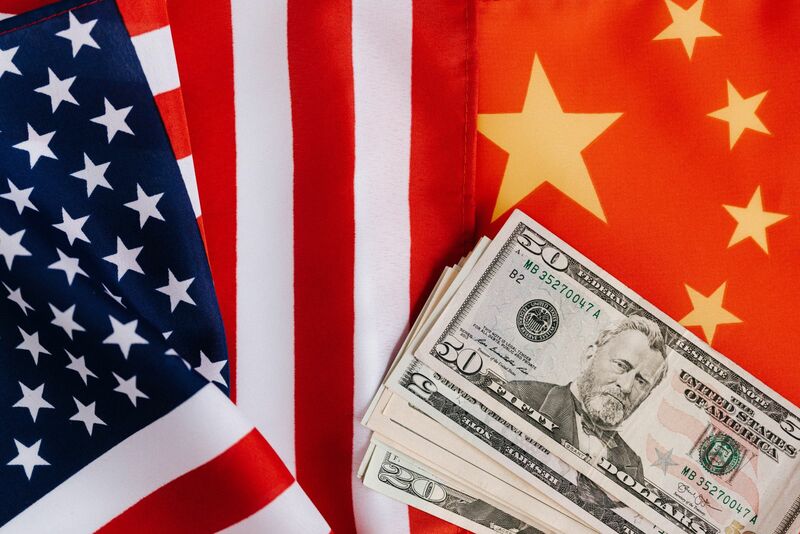 China - usd next to Chinese and American flags