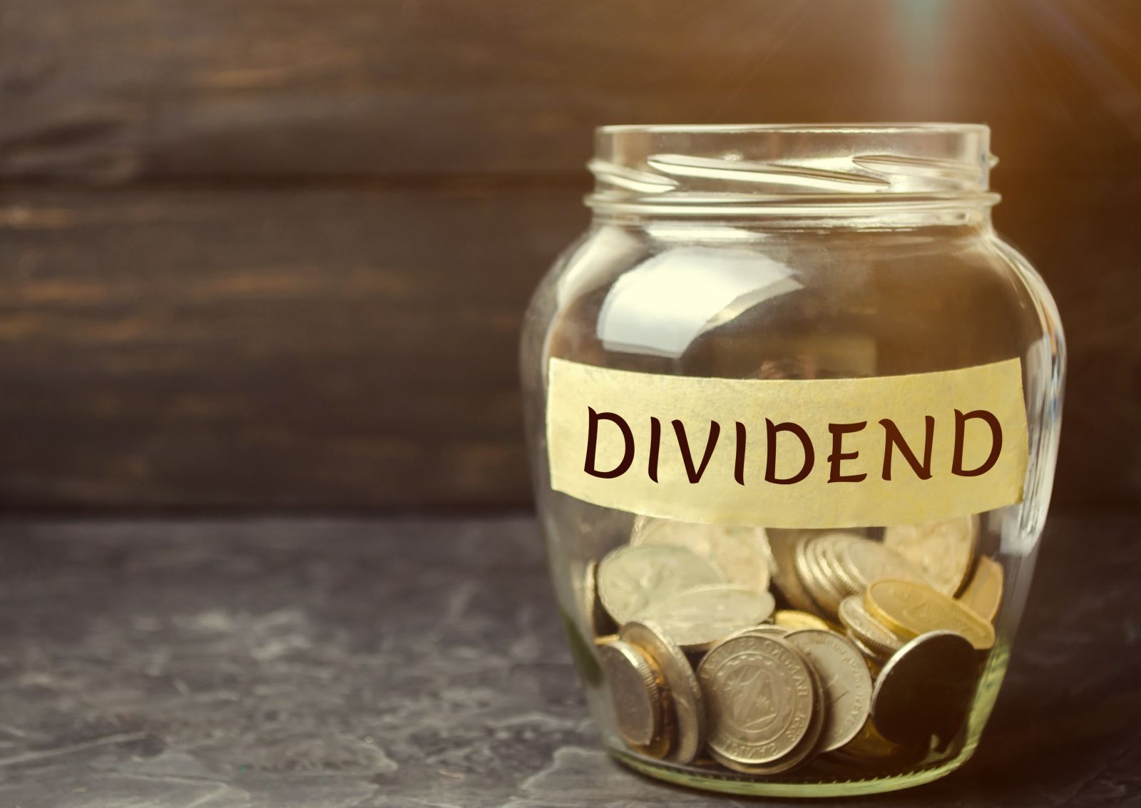 Dividends - Glass jar with the word Dividend by Andrii Yalanskyi via Shutterstock