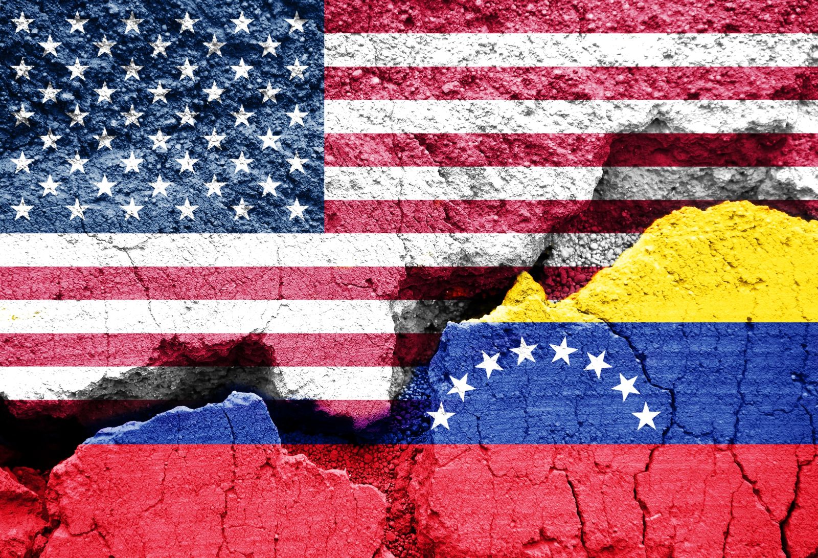 Flags of US and Venezuela on cracked ground background_ Image by Delpixel via Shutterstock_