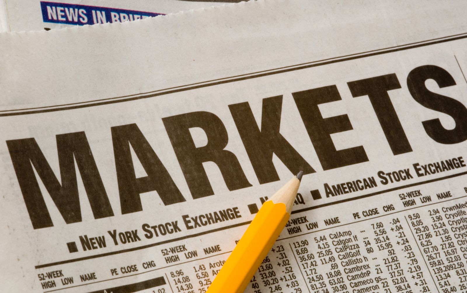 Wall Street - Newspaper open to market pages by Mike Flippo via Shutterstock