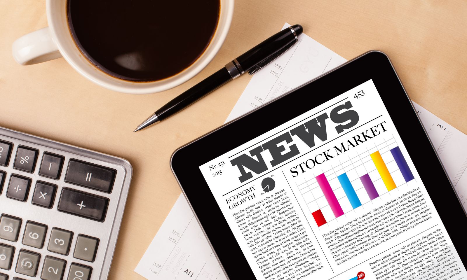 Wall Street - Workplace with tablet pc showing latest news and a cup of coffee on a wooden work table by ra2 studio via Shutterstock