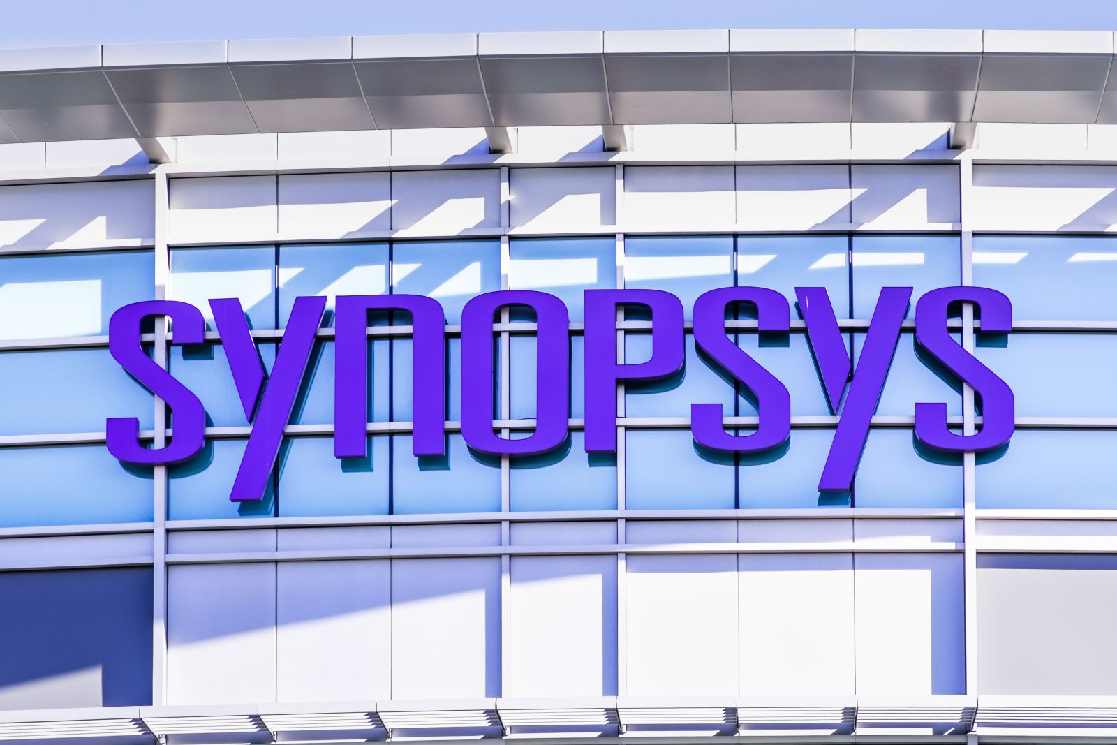 A close-up of the Synopsys sign on a corporate office by Sundry Photography via Shutterstock