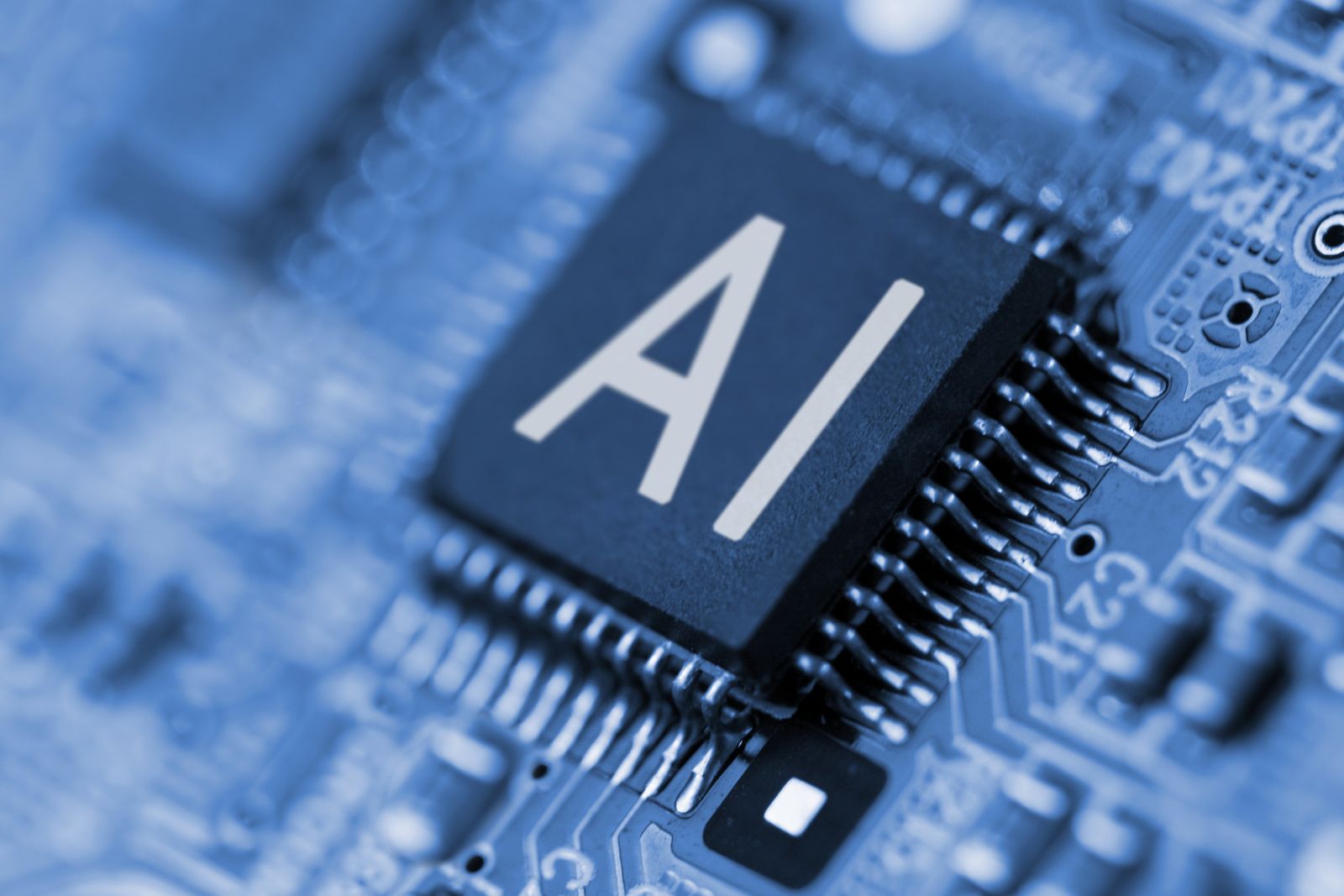 AI (artificial intelligence) - Close- up of computer chip with AI sign by YAKOBCHUK V via Shutterstock