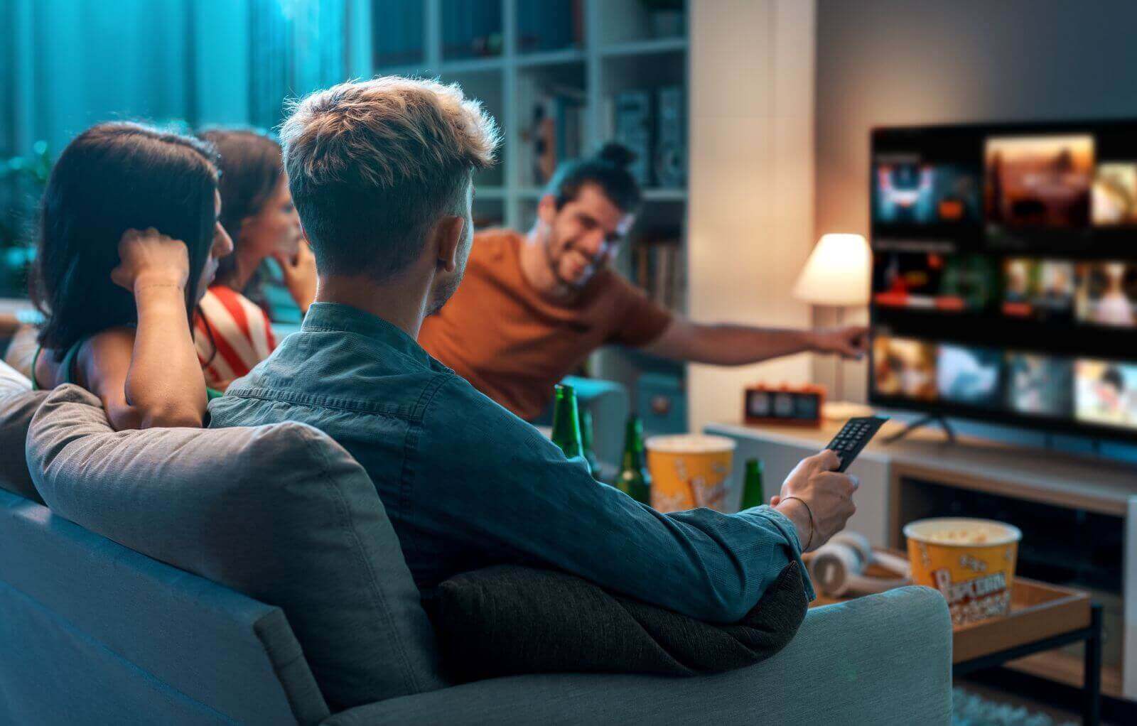 Friends choosing a movie on a streaming service by Stock-Asso via Shutterstock