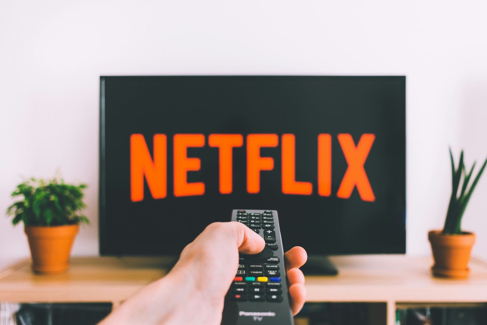 Tech (Ecommerce, Social Media, etc.) - Netflix on tv with remote by freestocks via Unsplash