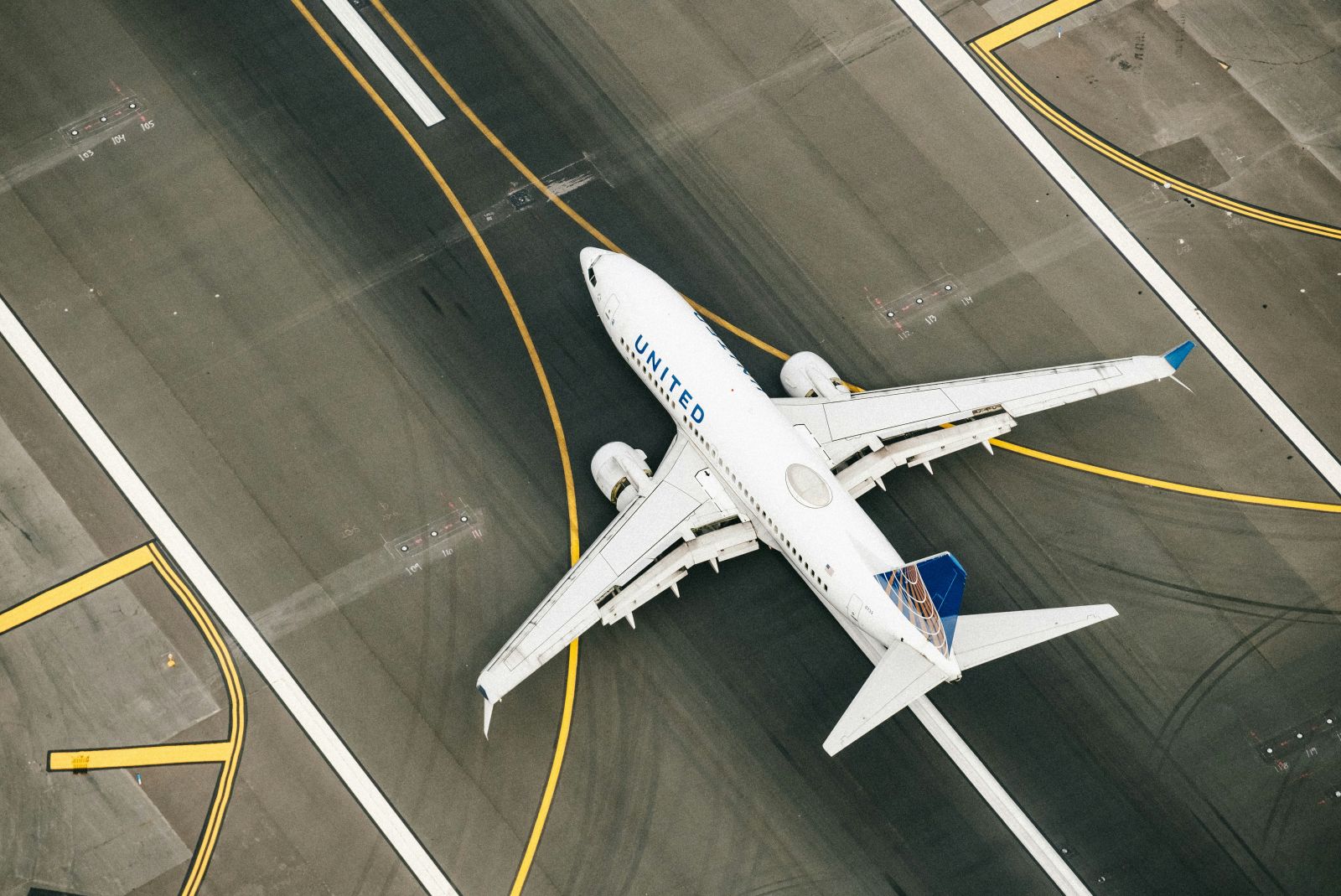 Travel & Leisure - White and blue plane on runway during dayime by Chris Leipelt via Unsplash