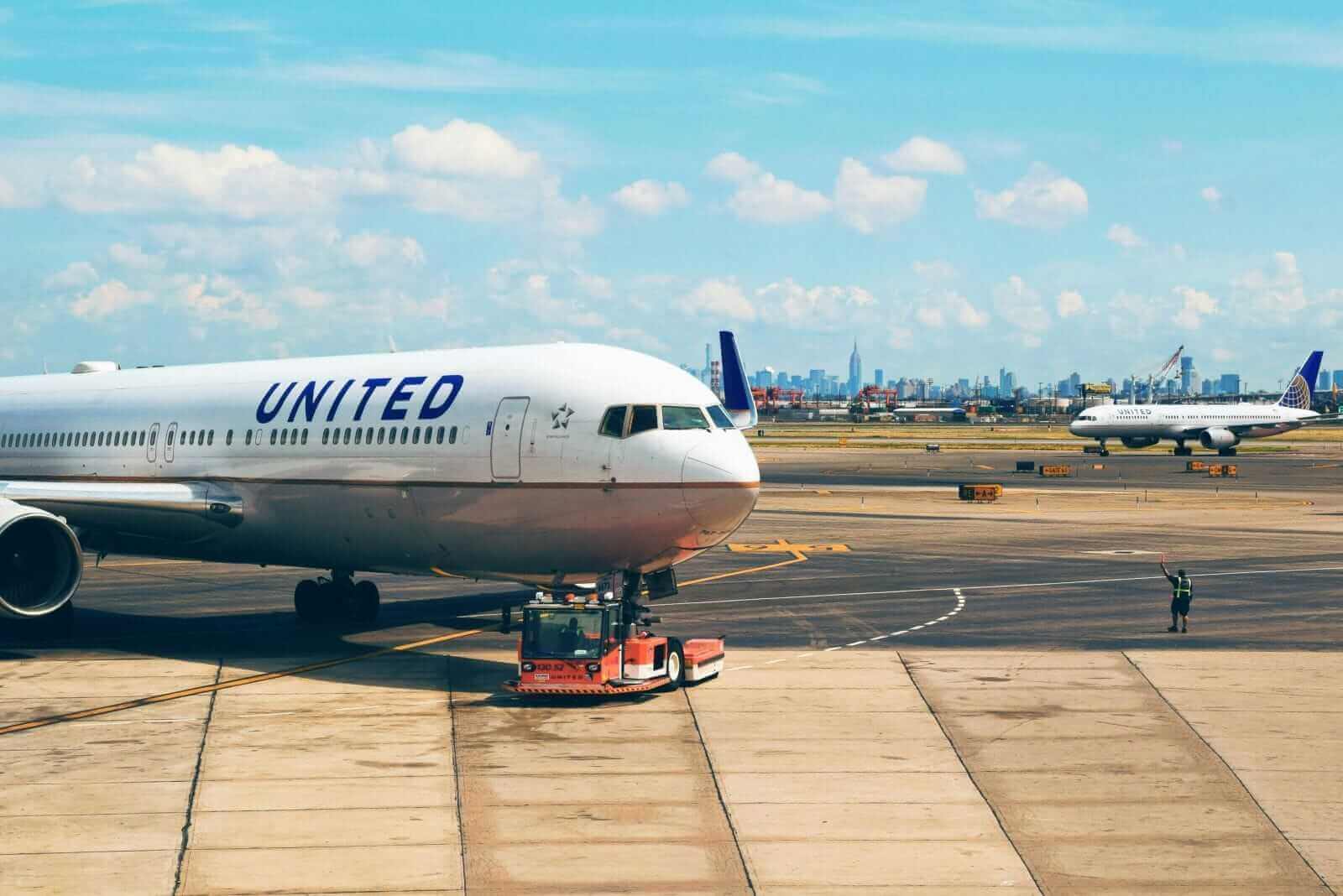White plane parked at airport by Tim Gouw via Unsplash