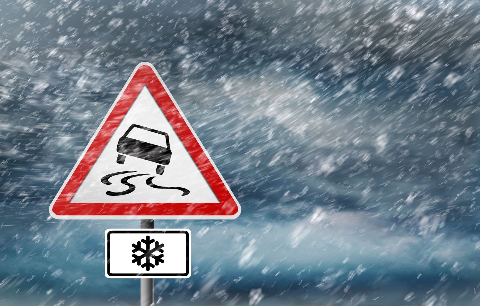 Warning Sign - Snow Storm - Slippery Road by peterschreiber_media via Shutterstock