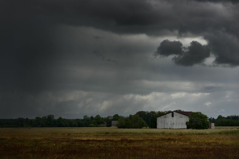 Weather - storm clouds over small farm